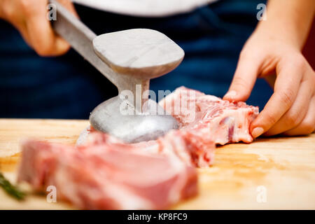 Young woman beating a steak,Young woman beating a steak,Young woman beating a steak,Young woman beating a steak,Young woman beating a steak,Young woman beating a steak,Young woman beating a steak,Young woman beating a steak Stock Photo