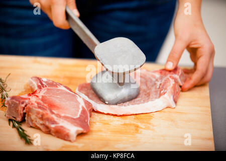 Young woman beating a steak,Young woman beating a steak,Young woman beating a steak,Young woman beating a steak,Young woman beating a steak,Young woman beating a steak,Young woman beating a steak,Young woman beating a steak Stock Photo