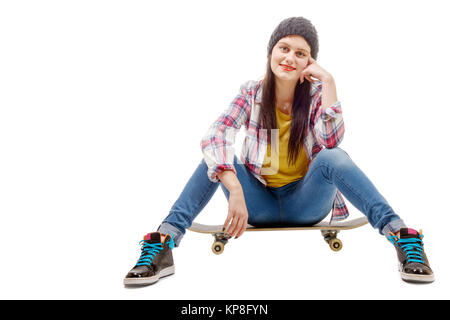 Beautiful young woman posing with a skateboard, seat on skate Stock Photo
