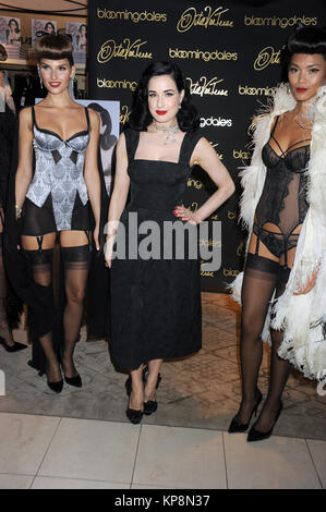 NEW YORK, NY - DECEMBER 02: Dita Von Teese poses with models during her visit to Bloomingdale's 59th Street Store to sign copies of her new book 'Your Beauty Mark' on December 2, 2015 in New York City.  People:  Dita Von Teese Stock Photo