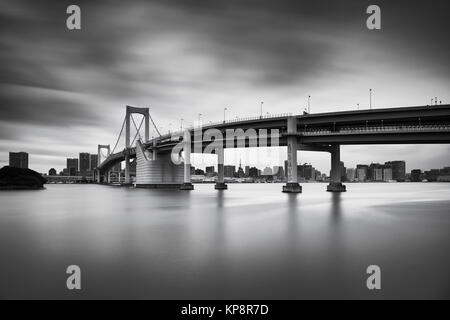 Black and white long exposure of the sunset sky over Rainbow bridge in Odaiba, Tokyo, Japan Stock Photo