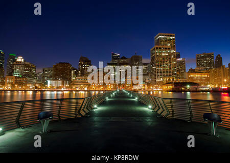 An image looking down pier 14 in San Francisco, California at night looking towards the Embarcadero. Stock Photo
