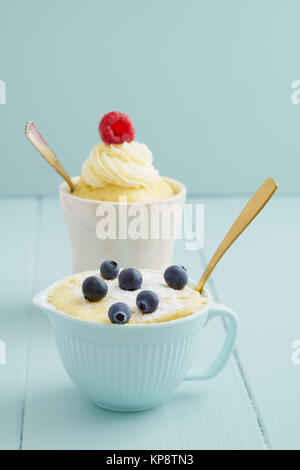 Vanilla mug cake in turquoise mug with spoon Stock Photo - Alamy