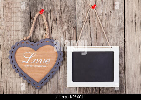 Empty wooden blackboard sign and heart shape frame Stock Photo