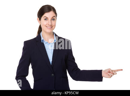 Brunette businesswoman with finger pointing aside Stock Photo