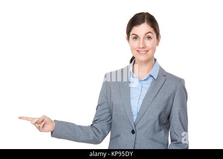 Brunette businesswoman with finger point aside Stock Photo