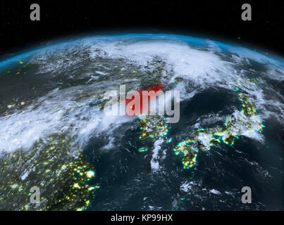 Satellite night view of North Korea highlighted in red on planet Earth with clouds. 3D illustration. Elements of this image furnished by NASA. Stock Photo