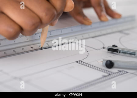Person's Hand Drawing Blue Print Stock Photo