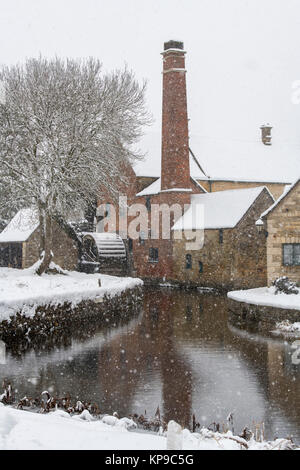 The Old Mill in the snow in December. Lower Slaughter, Cotswolds, Gloucestershire, England Stock Photo