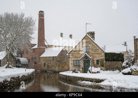 The Old Mill in the snow in December. Lower Slaughter, Cotswolds, Gloucestershire, England Stock Photo