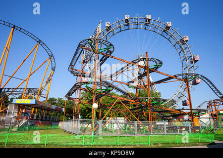 Dizzy Mouse roller coaster and Giant Ferris Wheel in Prater amusement park in Vienna city, Austria, Europe Stock Photo