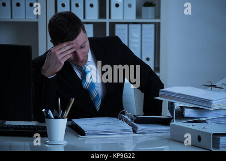 Stressed Accountant Working Late In Office