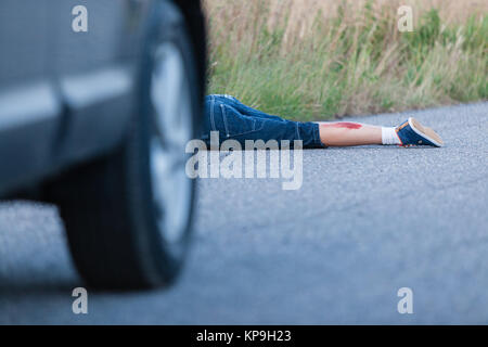 Boy Hit by a Vehicle Lying on the Road Wounded Stock Photo - Alamy