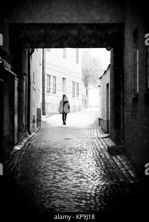 Person Walking in Alley Stock Photo