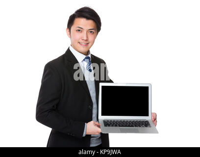 Asian businesswoman show with the blank screen of laptop computer Stock Photo