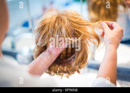 Woman holding wig. Stock Photo