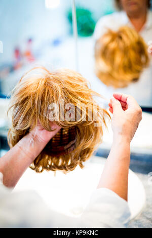 Woman holding wig. Stock Photo