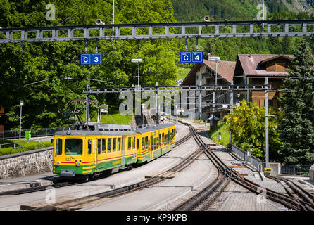 Train leaving the station of the Alpine village of Winteregg Stock ...