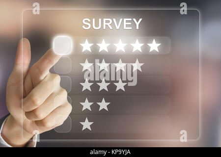 business hand pushing survey on virtual screen Stock Photo