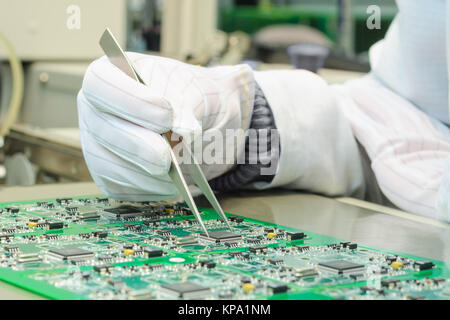 Quality control and assembly SMT printed components on circuit board Stock Photo