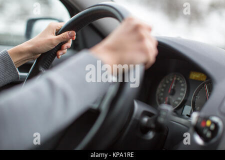 Driver's hands driving a car on a highway (color toned image  shallow DOF) Stock Photo