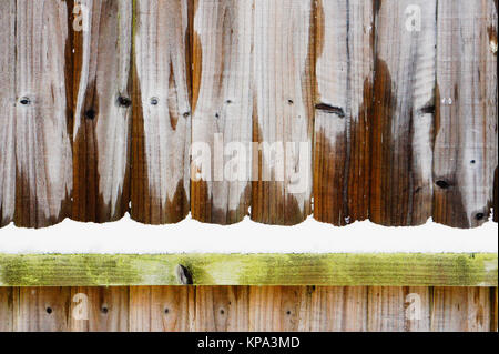 Part of a wooden garden fence with fresh snow Stock Photo