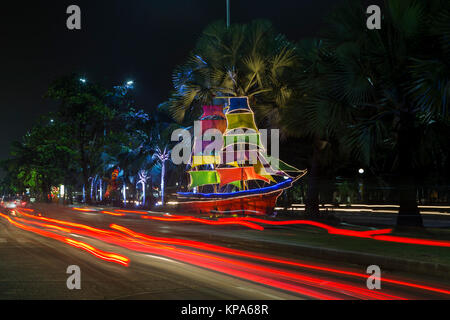 Scale model sailboats illuminated by colored lights on a street in Jakarta. Ancol beach nearby. INDONESIA Stock Photo