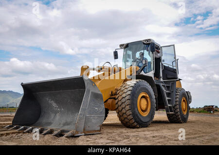 landscape photo of wheel loader in construction site with cloudy sky Stock Photo