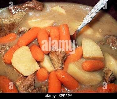 Crock Pot Beef Stew with carrots, potatoes, lean stewing beef in a rich thick gravy Stock Photo