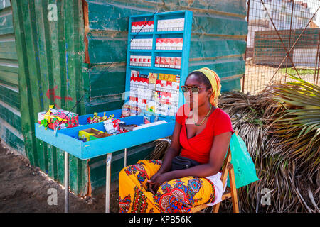 Woman selling cigarettes and tobacco from a stall on a street corner, Santa  Maria, Sal Island, Salina, Cape Verde, Africa Stock Photo