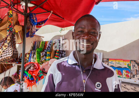 Stall holder selling souvenirs to tourists on the street in Santa Maria, Sal Island, Salina, Cape Verde Stock Photo