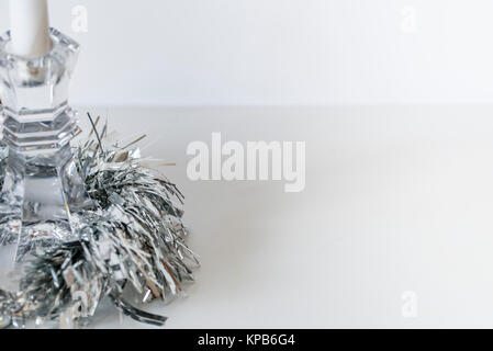 Christmas candle holder decoration, silver, white background, room for copy. Closeup of glass candlestick, silver sparkling decoration, room for text. Stock Photo