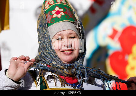 Belarus city of Gomel. The celebration of the national Russian holiday "Farewell to winter carnival" 25.02.2017 year. Russian woman in a headdress.Rus Stock Photo