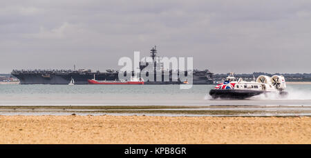 American aircraft carrier, USS George HW Bush visiting Portsmouth, anchored in The Solent at Stokes Bay, near Gosport and Gilkicker Point Stock Photo