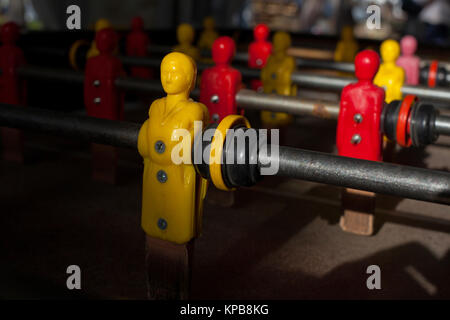 Close up view of a yellow player on a football toy. Stock Photo