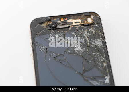 A badly cracked second generation iPhone on a white background Stock Photo