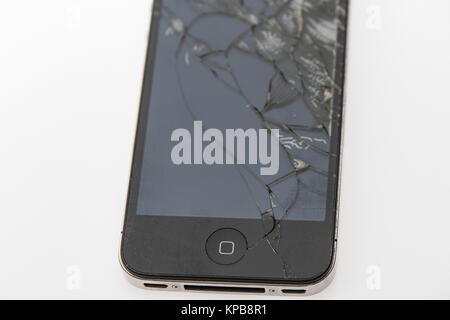 A badly cracked second generation iPhone on a white background Stock Photo