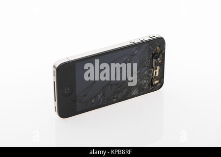 A badly cracked second generation iPhone on a white background Stock Photo