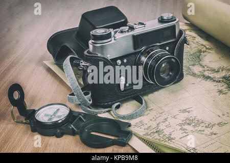 Items needed for travel: a large backpack, compass, camera, map of the world. Vintage items in retro style Stock Photo