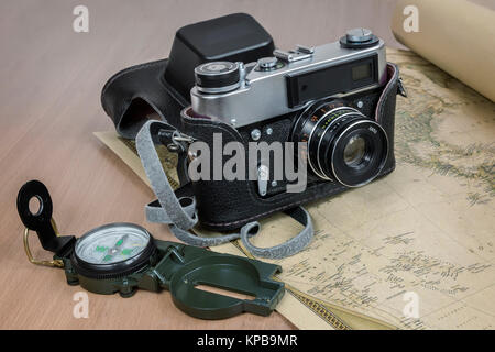 Items needed for travel: a large backpack, compass, camera, map of the world. Vintage items in retro style Stock Photo