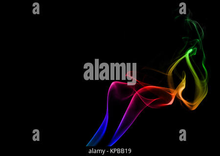 Flowing rainbow smoke against the black background Stock Photo