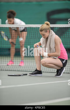 girls tired after tennis match Stock Photo