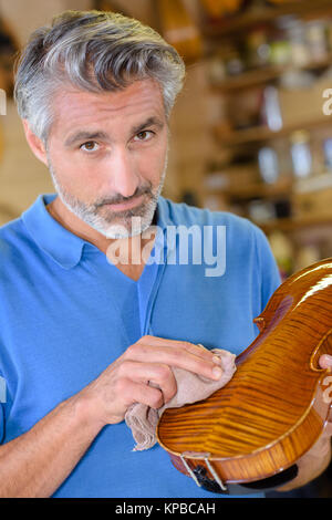 portrait-of-luthier-polishing-a-violin-stock-photo-alamy