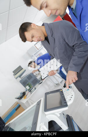 man fixing photo copier Stock Photo