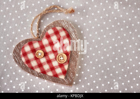 Wooden heart on cotton napkin with polka dots. Happy Valentine! Stock Photo