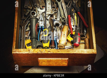 Closeup view of drawer full of old used tools. Stock Photo