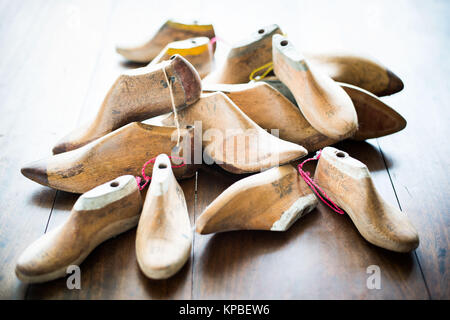 Pairs of old wooden shapes to make shoes. Stock Photo