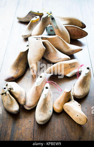 Pairs of old wooden shapes to make shoes. Stock Photo