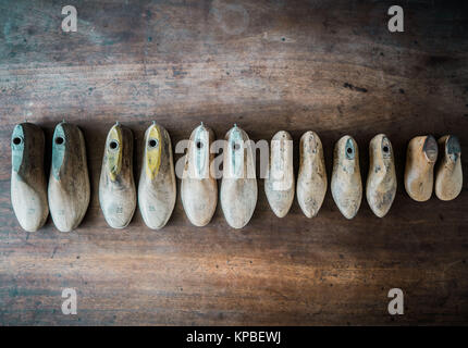 Pairs of old wooden shapes to make shoes. Stock Photo