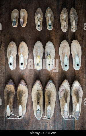 Pairs of old wooden shapes to make shoes. Stock Photo